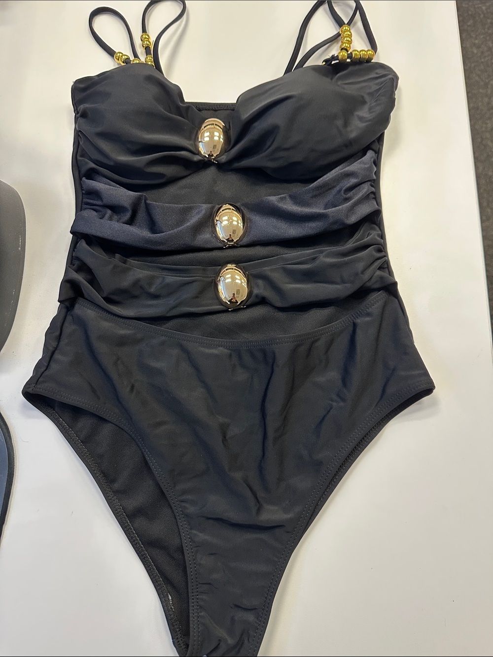 Elegant Black One-Piece Swimsuit with Gold Orb Accents